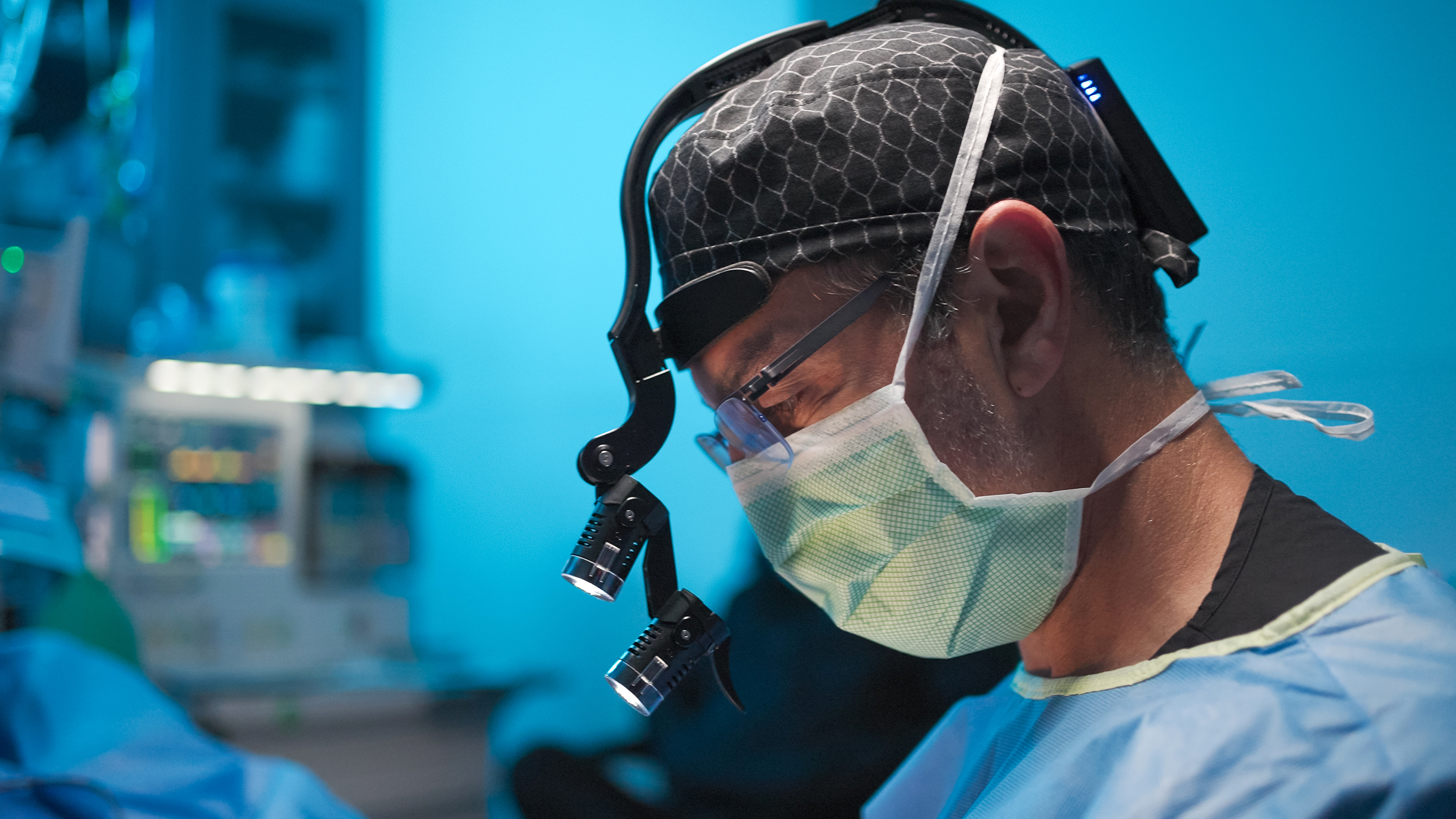 Richard V Balikian, MD FACS — Dr. Balikian using surgical loupes for precision during a facial plastic surgery procedure.